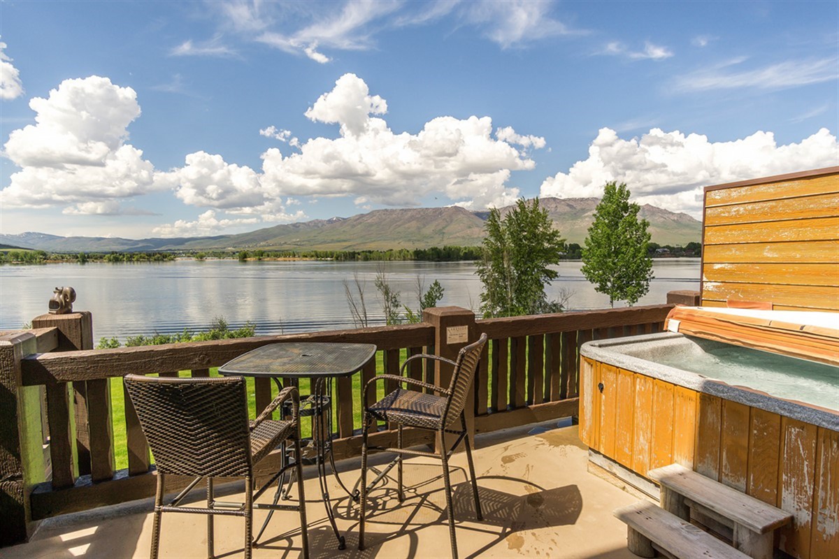 Relax in your private hot tub while taking in panoramic water and mountain views—luxury living at its finest.