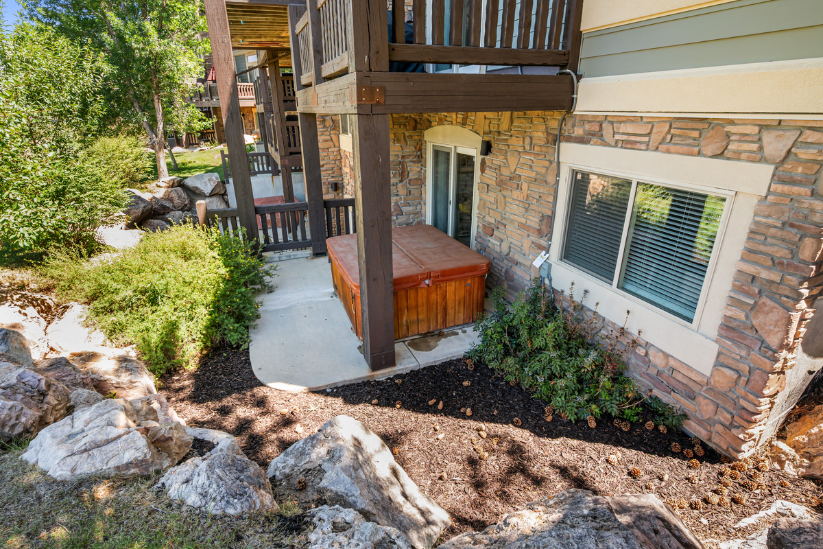 Private hot tub nestled beneath the upper deck for year-round enjoyment.