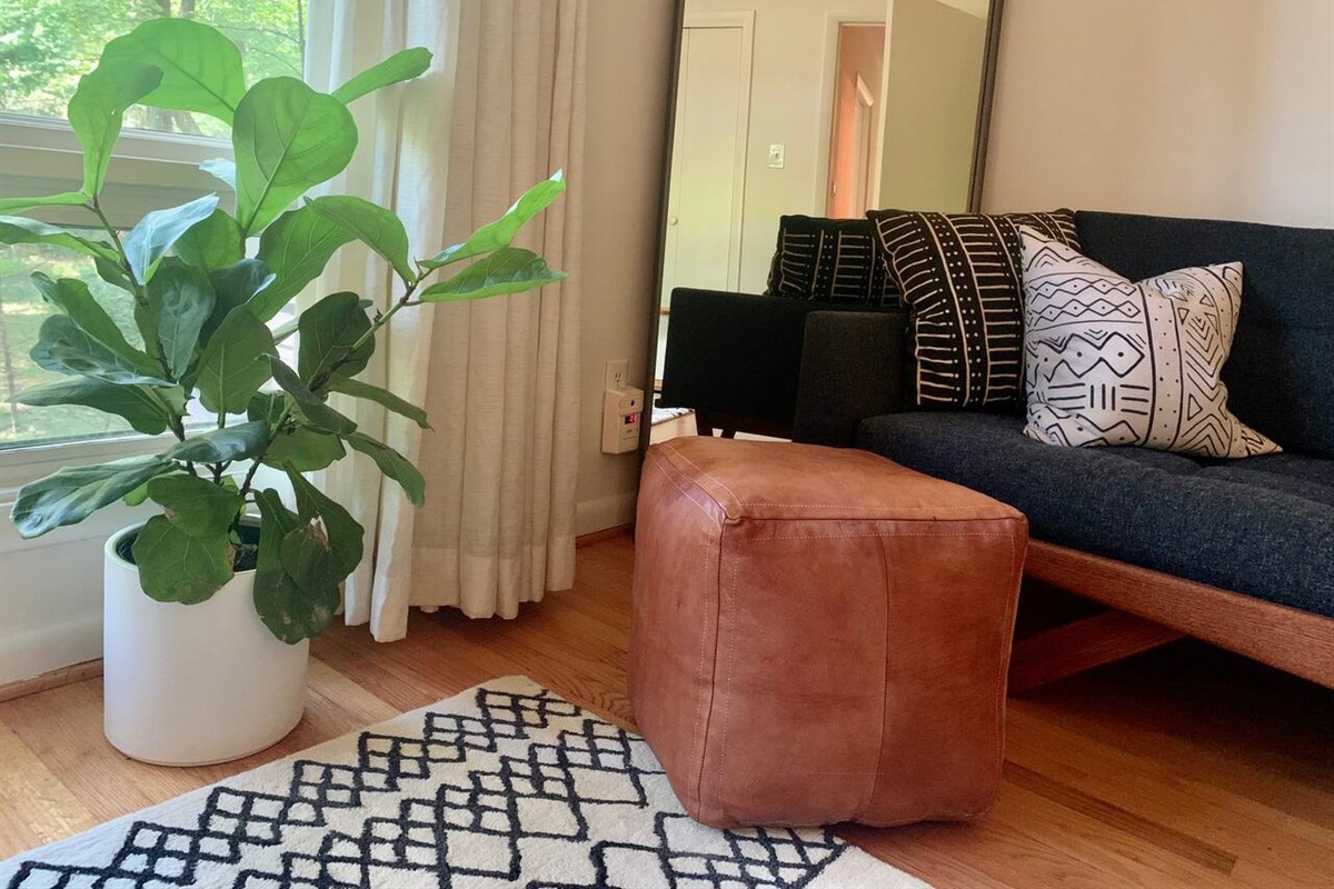 This spacious bedroom overlooking the backyard has its own custom designed couch. Put your feet up. Relax.
