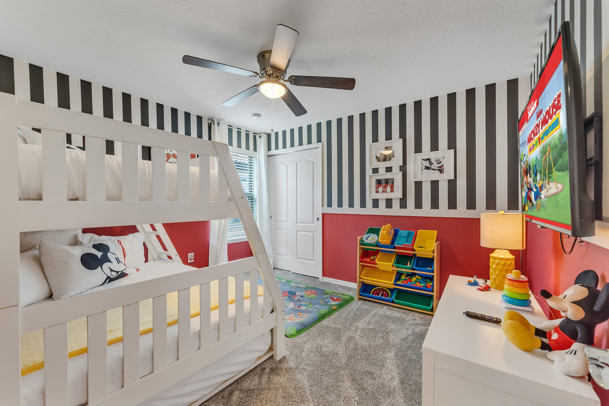 Mickey Mouse room with bunk bed (twin on top and in trundle below, full on bottom).  Room includes toys for kids.