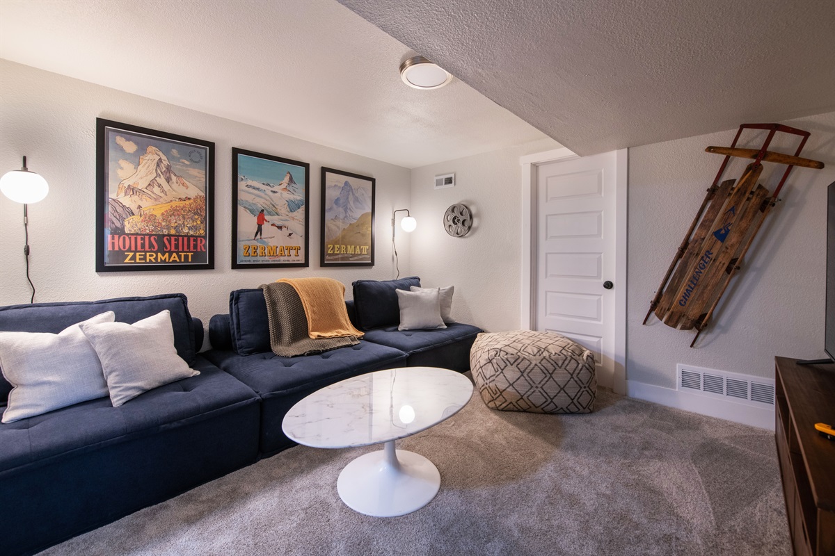 Lower-level movie theater hangout area, including ultra comfy lounger sofa that converts to a bed to fit 2-3 people easily.