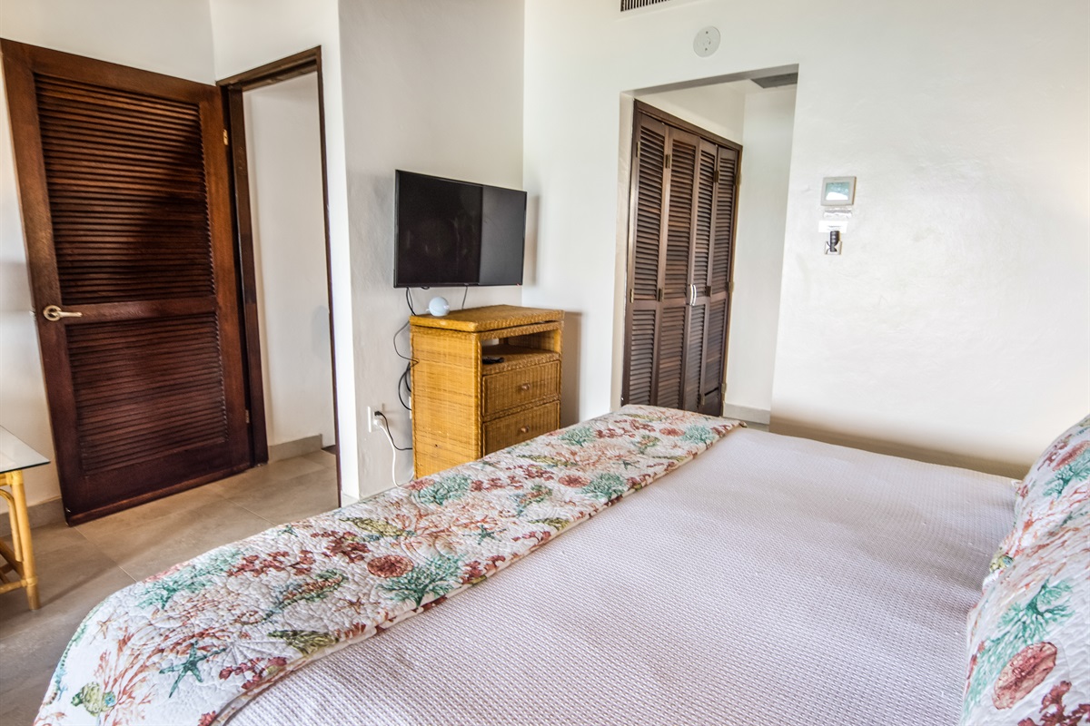 Unwind in the spacious primary bedroom featuring a plush king-size bed.
