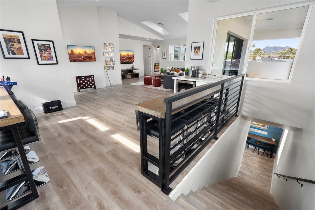 This cozy kitchenette features seating, dedicated coffee machines, and a wine cooler, making it perfect for relaxing with friends or enjoying a quiet cup of coffee. Plus, enjoy a fun blitz arcade game for entertainment!