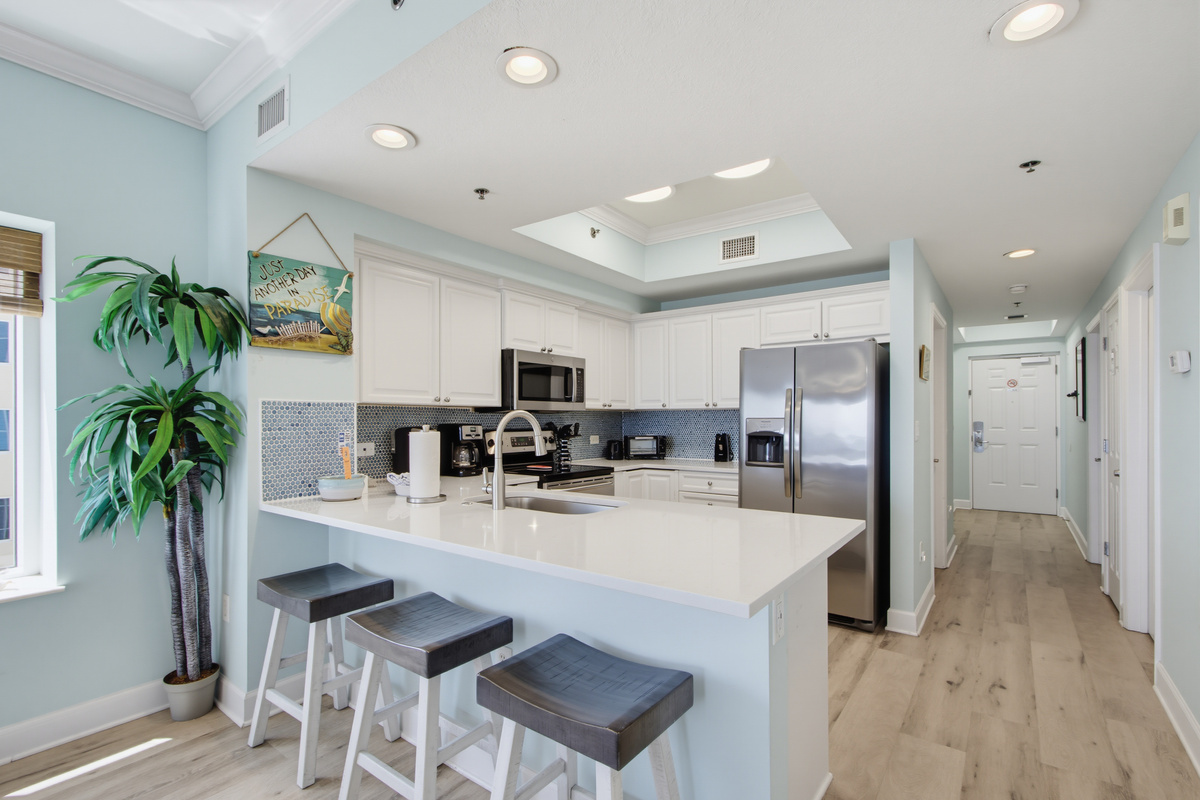 Updated kitchen with island seating and generous counter space.