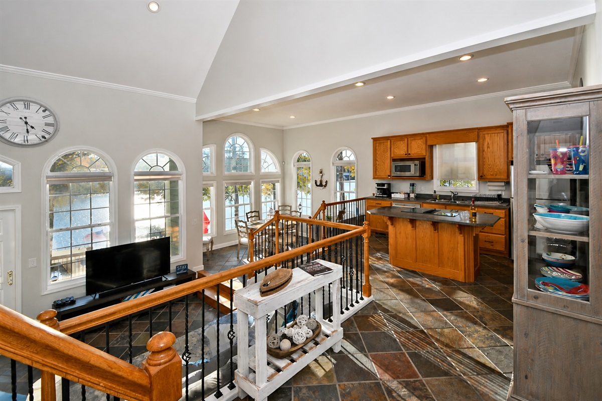 Foyer overlooks the open floor plan of the kitchen, dining, and living spaces