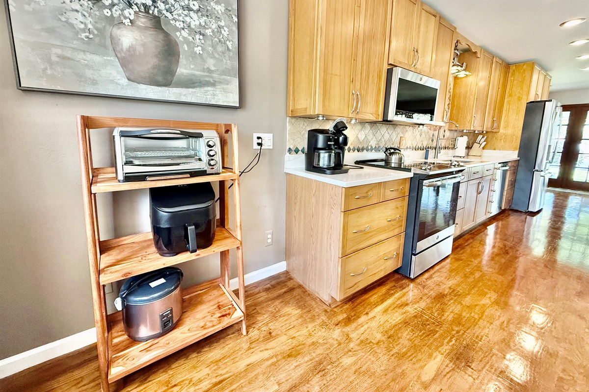 This thoughtfully designed kitchen is both practical and beautiful, featuring a striking tile backsplash, recessed lighting, and everything you need to feel at home.