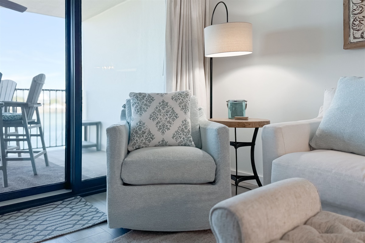 A tranquil corner offering the perfect spot to unwind and soak in the breathtaking water views. This cozy chair invites moments of peaceful contemplation.