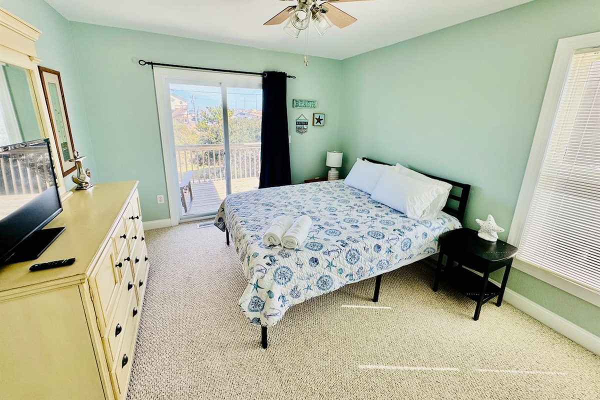 Bright Queen room with sliding door to private deck.