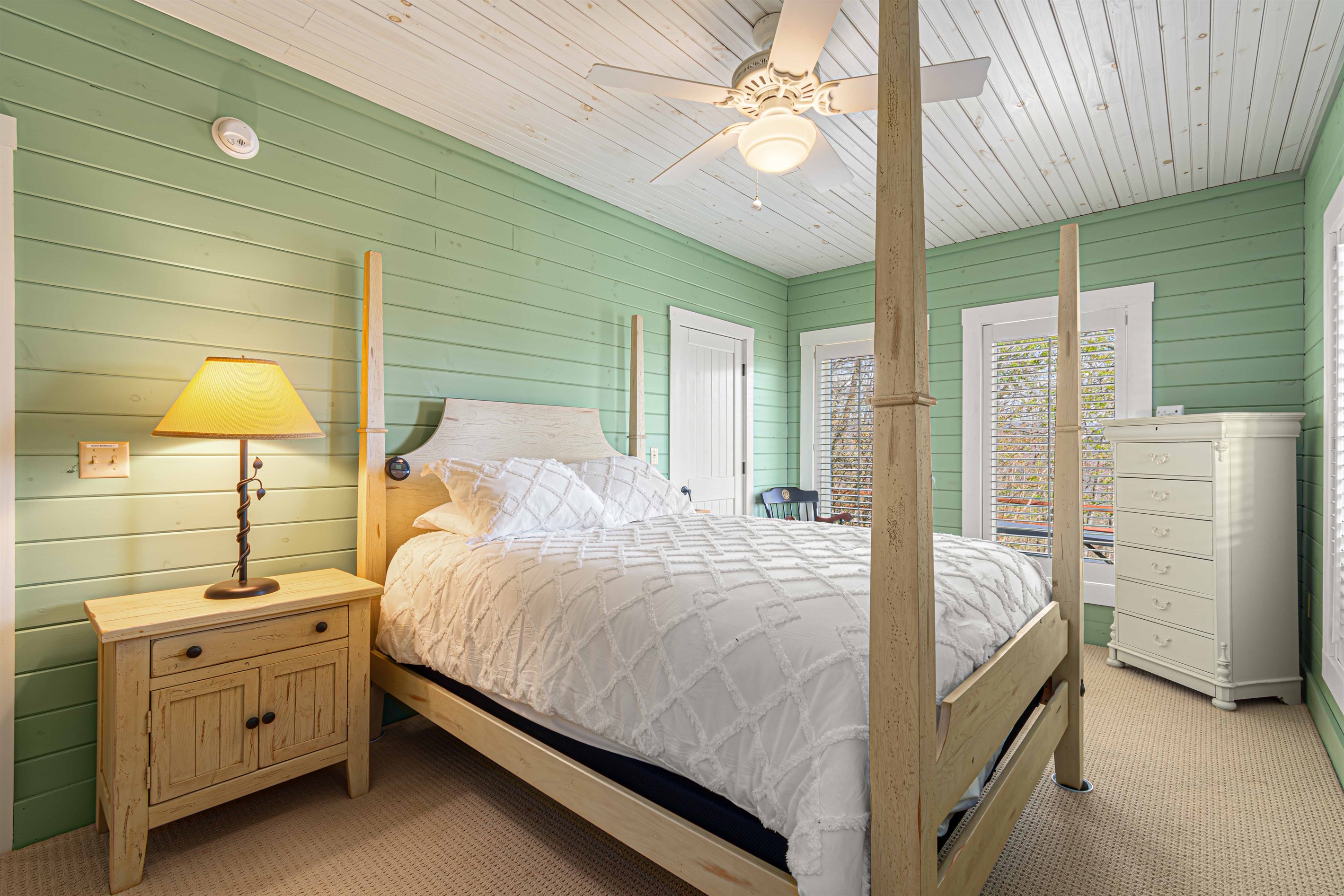 Downstairs Queen Bedroom 4: Relax in this airy room with natural light, a plush bed, and charming decor!