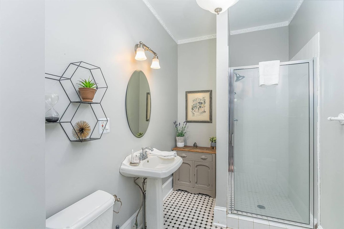 First floor full bath at the end of the entryway hallway.