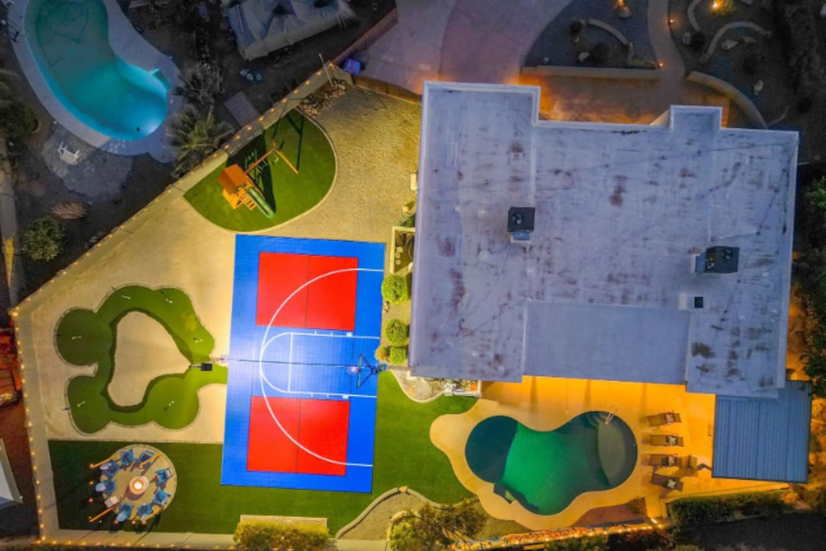 Every amenity laid out at once: pool, court, putting green, playground — a full day of options without leaving the yard.