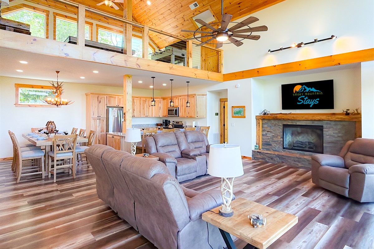 The living room features a 65" Smart TV, electric fireplace for cold nights, and plenty of comfy seating for your group.