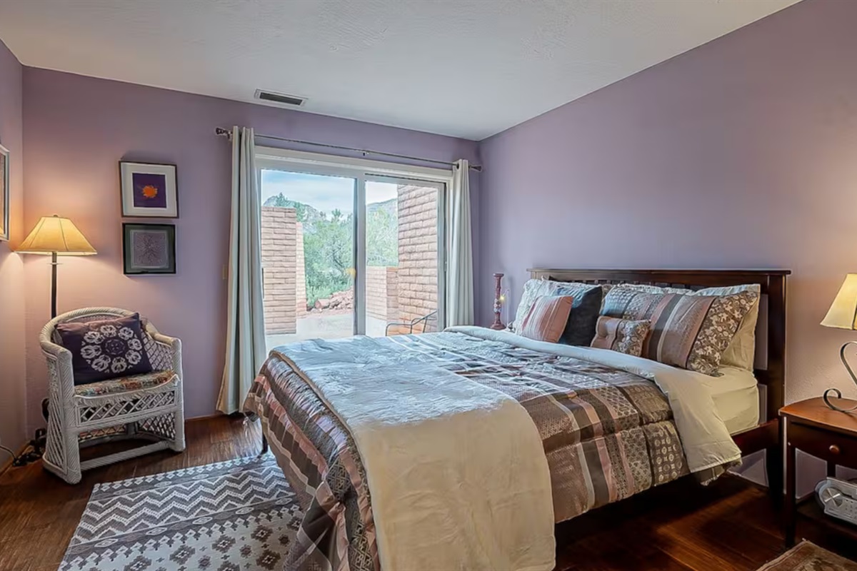 Private lower-level guest suite featuring a dedicated bathroom nearby and seamless access to the outdoor patio.