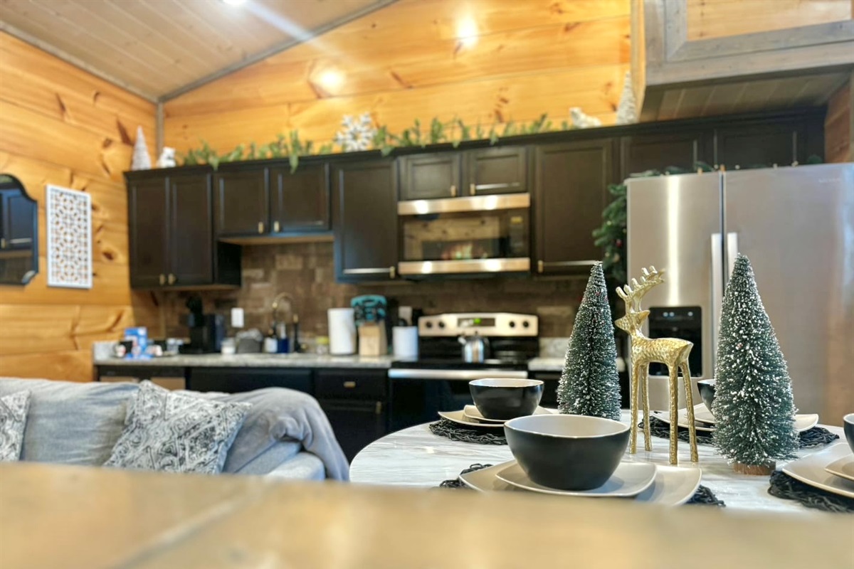 Prepare meals surrounded by sleek stainless appliances and festive touches, blending the comfort of home with the joy of a mountain-side holiday escape.