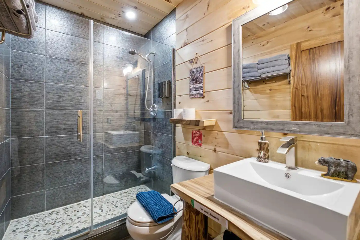 Bathroom with glass shower, vanity and practical storage