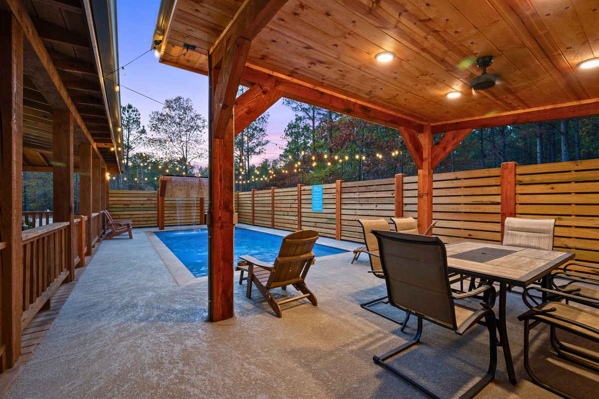Just off the pool, the covered patio offers a shaded spot to lounge, eat, or enjoy a slow morning outdoors.