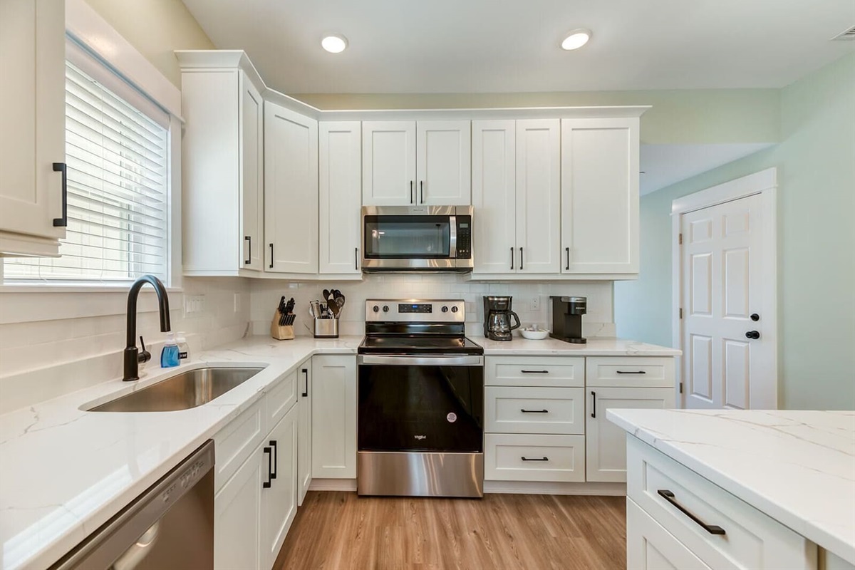 Modern coastal kitchen with stainless steel appliances and everything needed for easy vacation meals.
