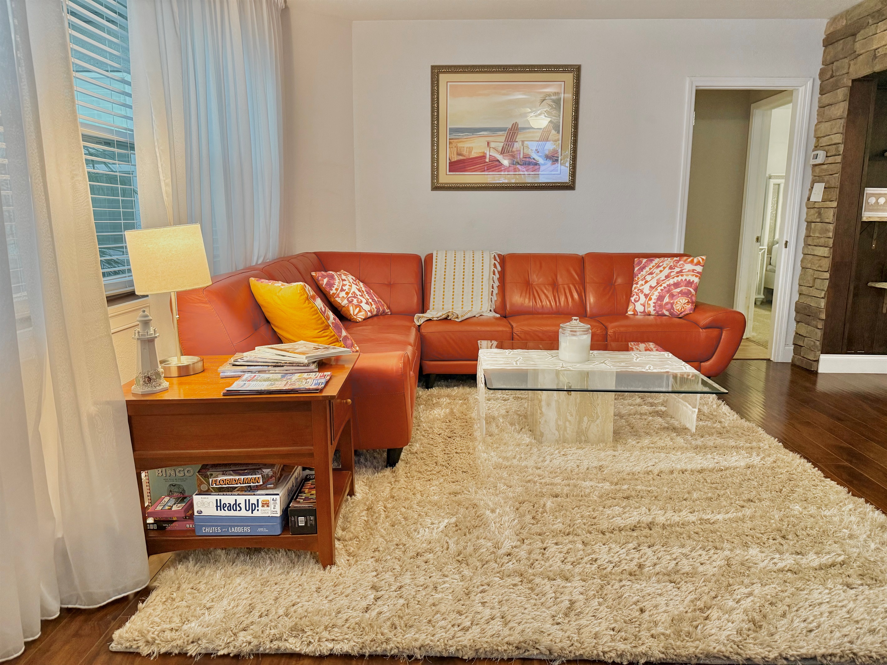 Sunlight pours through large windows, creating a bright and tranquil vibe in this thoughtfully designed lounging area.
