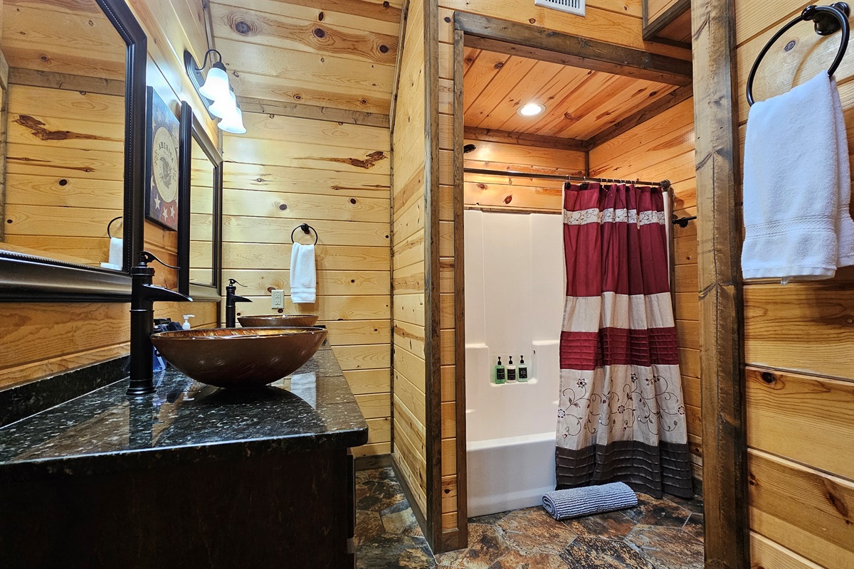 Bathroom Oasis: Natural wood accents and stylish fixtures create a rejuvenating retreat!