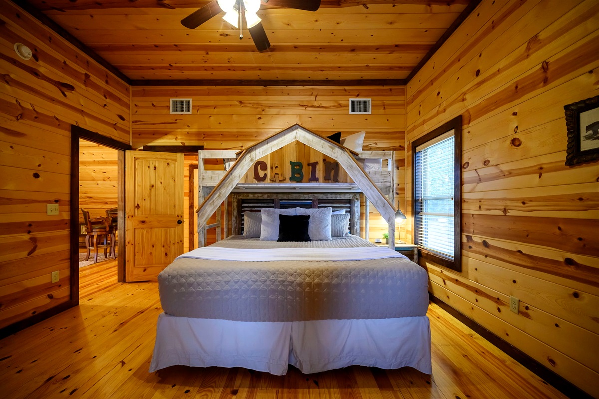 Cabin-themed king suite &mdash; rustic charm meets plush comfort.