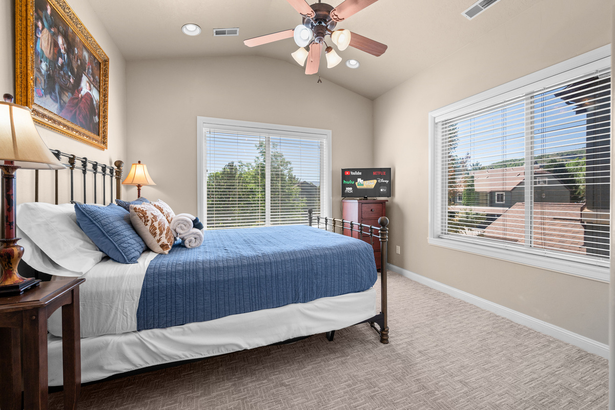 Bright and airy bedroom with a cozy queen bed and abundant natural light.