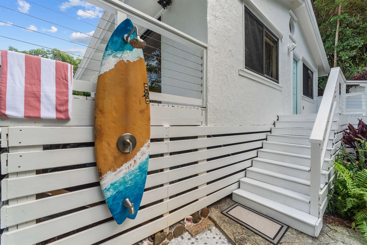 Stairs leading up to the front door of the home. A convenient outdoor shower for rinsing off sand before entering the property.