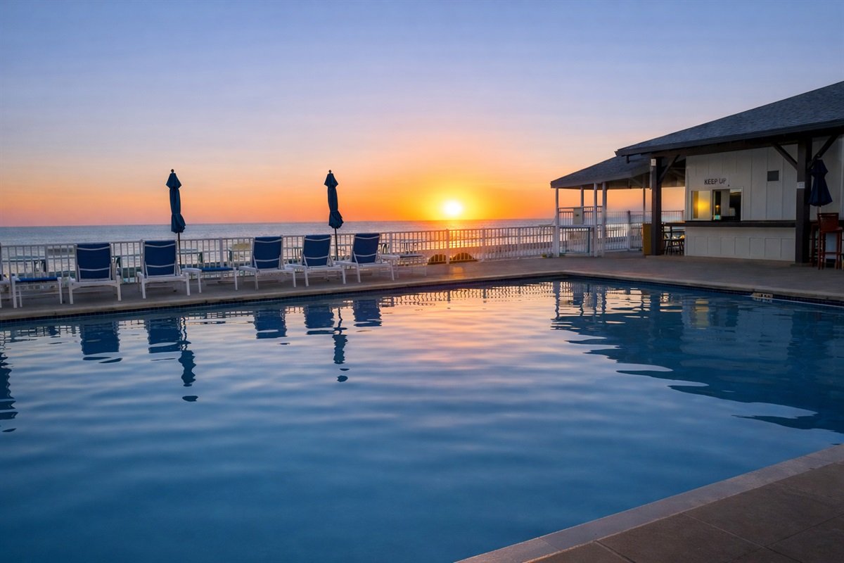 Relax in the shade, breathe in the ocean air, and watch the sunset melt into the horizon beside the serene pool.