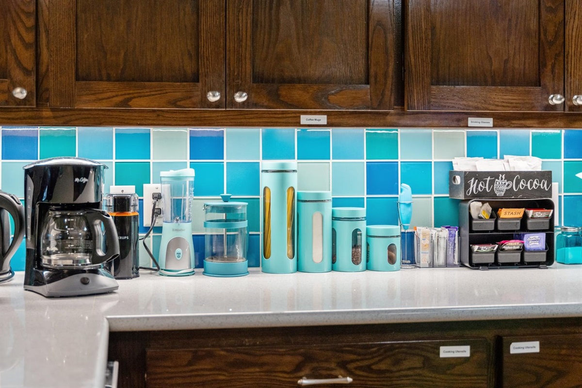 A well-stocked coffee and beverage station featuring a coffee maker, French press, and hot cocoa bar—perfect for starting your morning or unwinding with a warm drink in this wonderful kitchen.