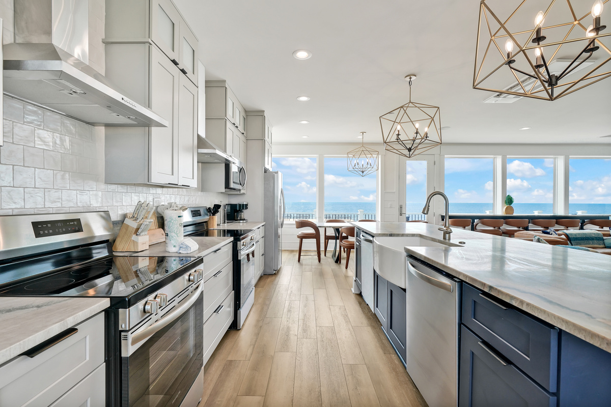 A kitchen with a view and two fridges, two microwaves, two stoves, and two ovens
