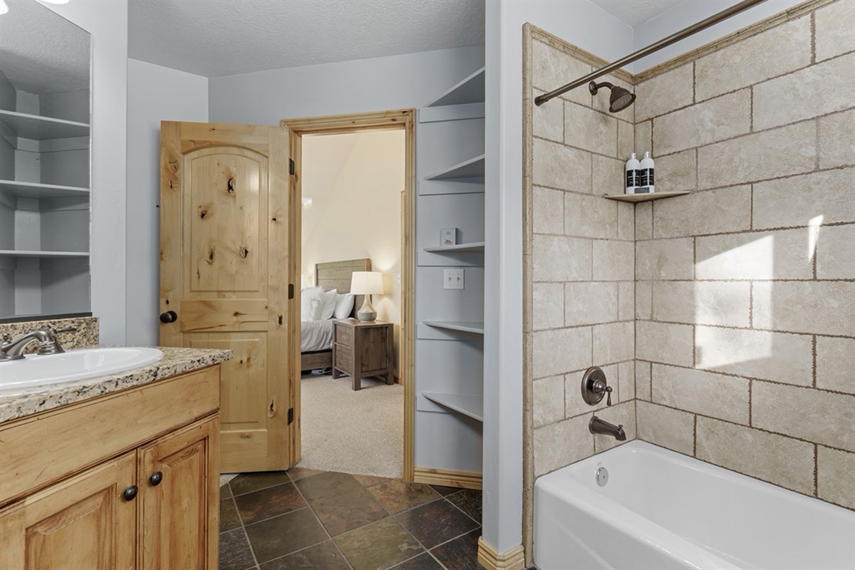 Full bathroom with a tub/shower combo and clean, modern finishes.