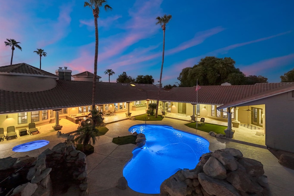 Framed by towering palms and elegant architecture, this poolside courtyard feels like a five-star retreat.

