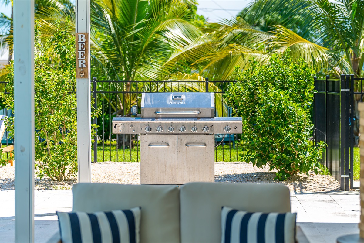 Fire up the stainless steel grill for the ultimate backyard cookout, surrounded by lush tropical landscaping. With plenty of space to relax nearby, it’s perfect for outdoor dining and entertaining under the Florida sun.