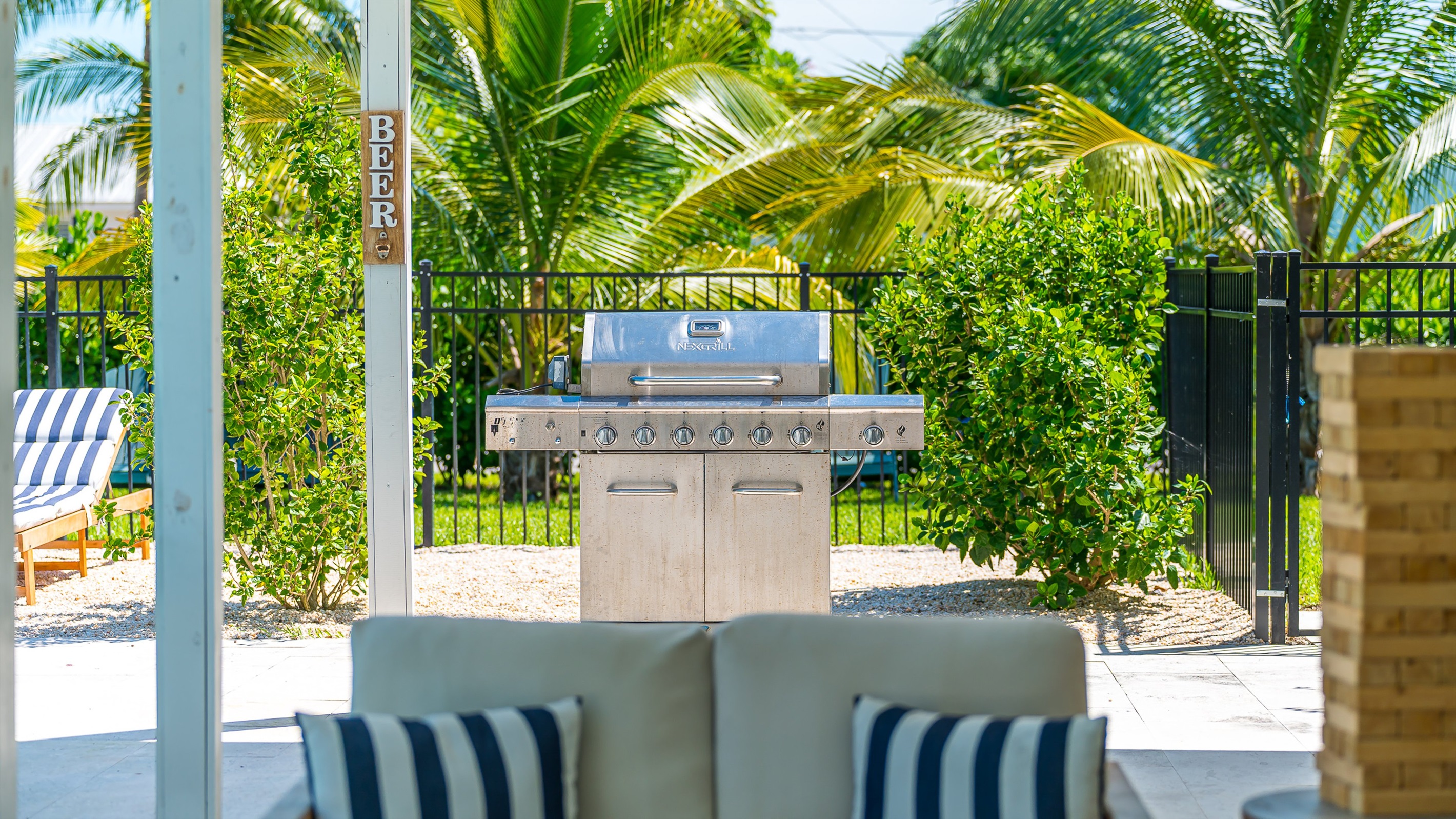 Fire up the stainless steel grill for the ultimate backyard cookout, surrounded by lush tropical landscaping. With plenty of space to relax nearby, it’s perfect for outdoor dining and entertaining under the Florida sun.