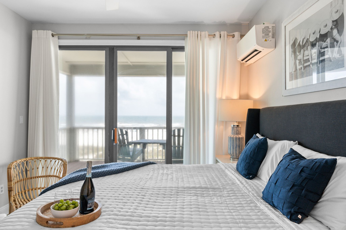 Enjoy indoor-outdoor living with a cozy bedroom, ensuite bathroom, and sliding glass doors framing the beautiful gulf.