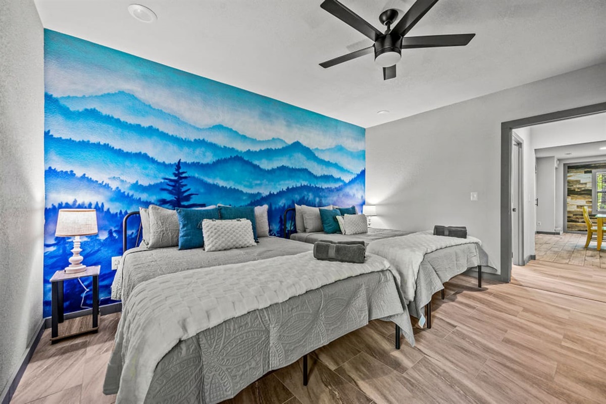 Downstairs bedroom with two queen beds and TV