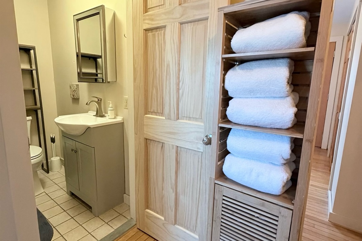 High quality white linens and professional styling create a serene atmosphere in the master suite.