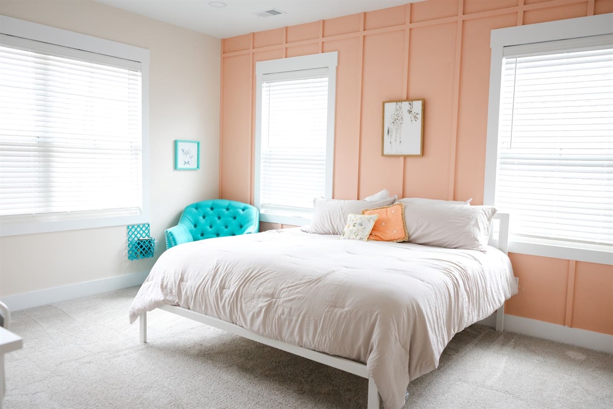 Bright and cheerful, with a super comfy chair for reading and a desk. Private sink and makeup vanity area with access to private toilet and shower rooms, which are shared with bedroom #5.