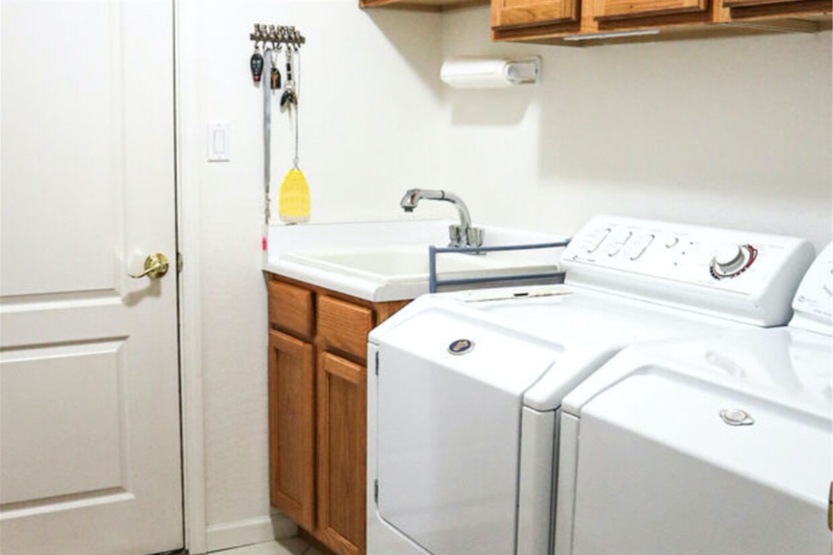 Laundry room has washer and dryer and a sink for your convenience.