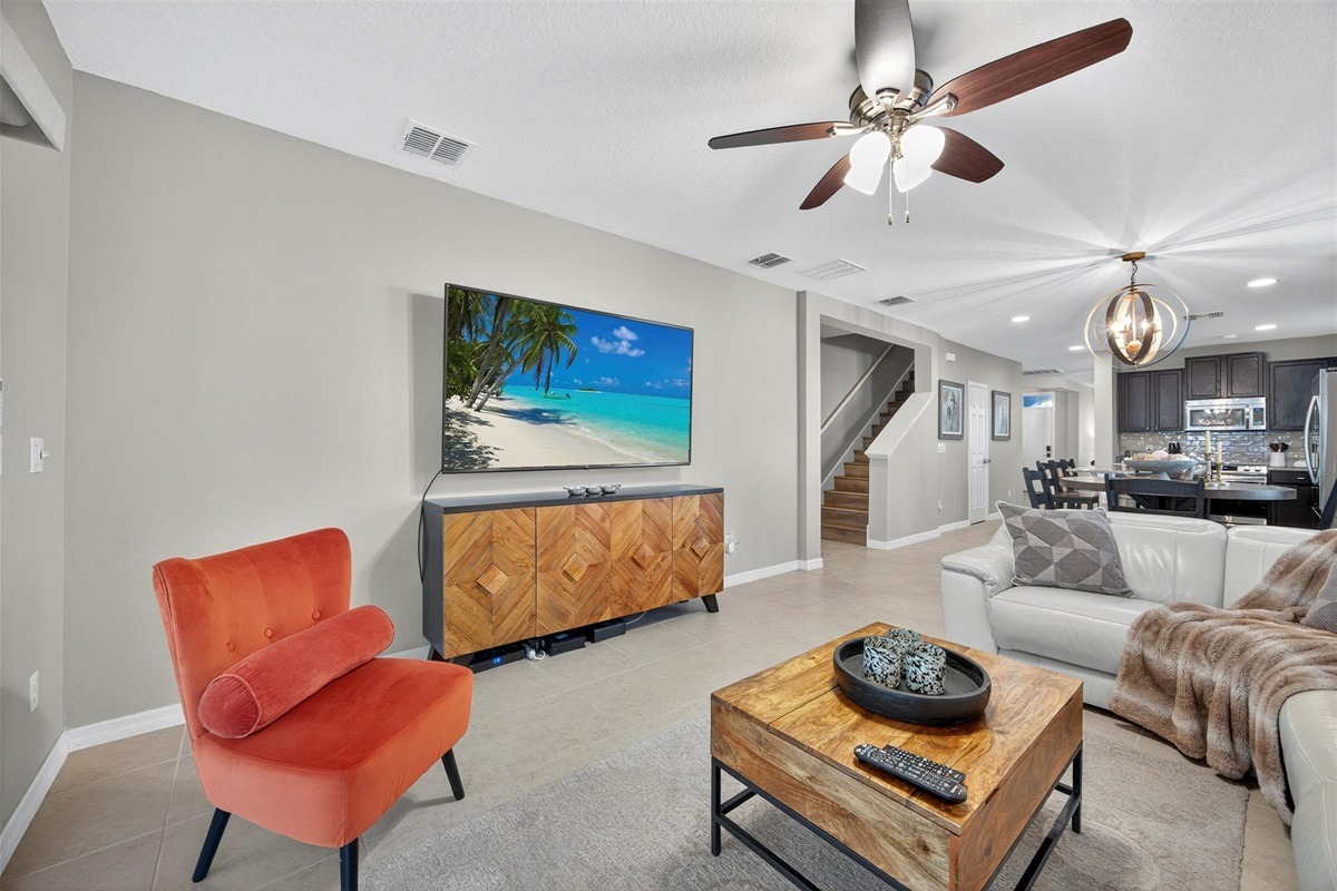 Bright and inviting living room with comfy seating and a large Roku Smart TV.