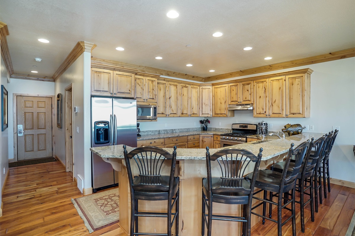 Beautiful kitchen with bar seating and open flow into the living space.