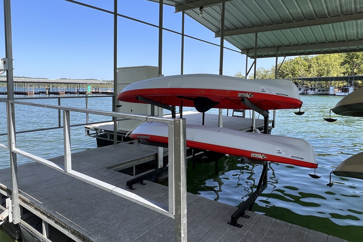 4 kayaks and 1 paddle board with life jackets and paddles