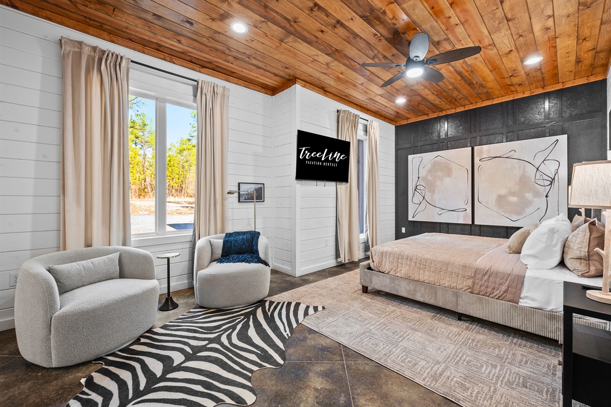 Natural light pours into this stunning bedroom, creating a bright and airy retreat with stylish decor and thoughtful touches.