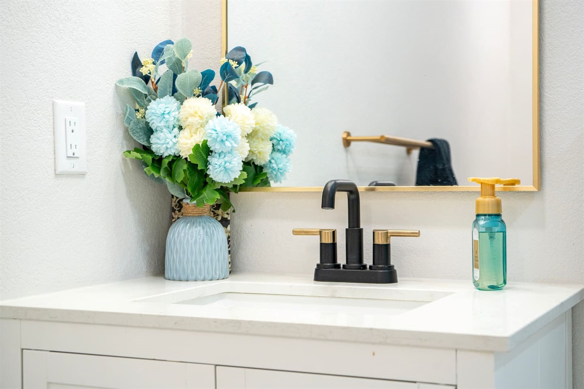 Modern vanity with designer fixtures and thoughtful styling for a clean, elevated feel