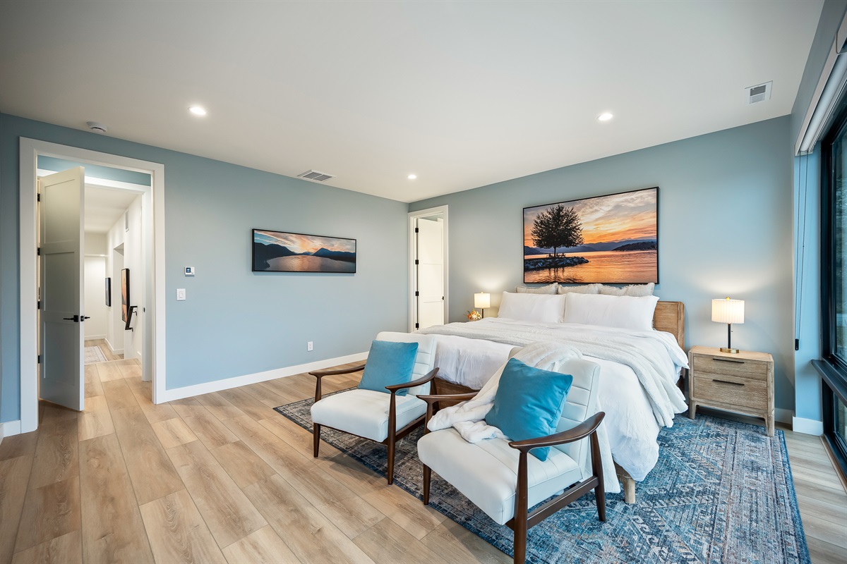 Primary: Bedroom #6 of 7 - Upstairs, king bed, Smart TV, large walk-in closet with crib, and ensuite with soaking tub, walk in shower, and lake views