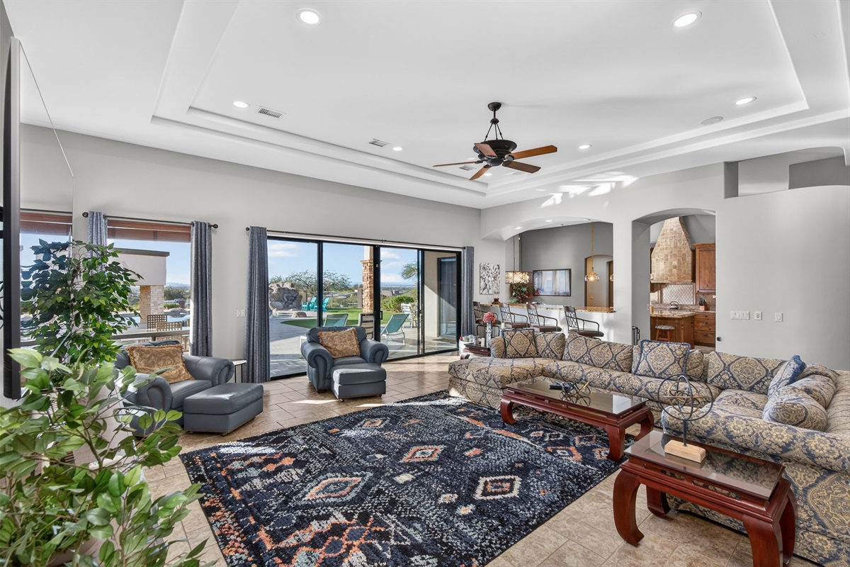 Bright living space with panoramic backyard views — indoor comfort seamlessly connected to outdoor desert beauty