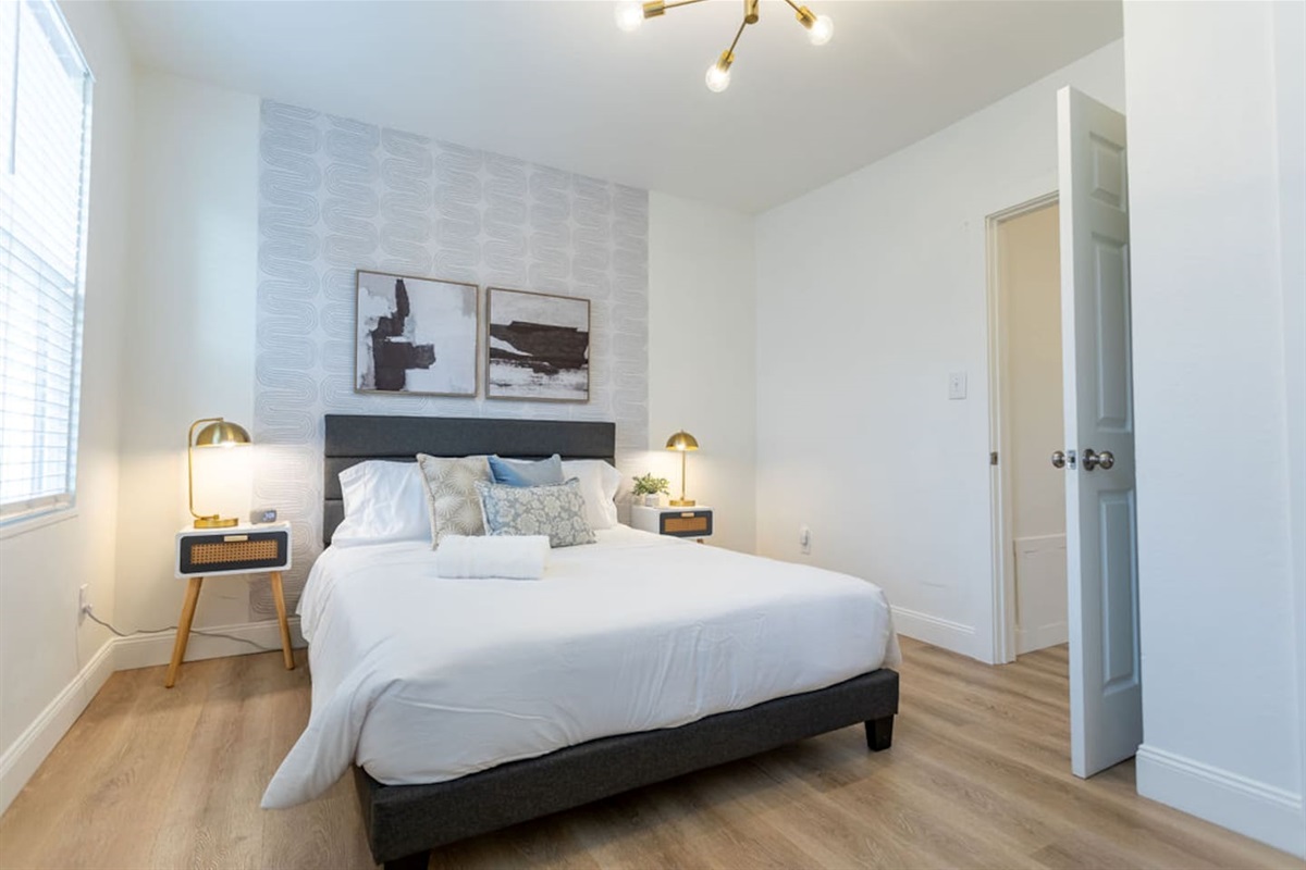 Bright and spacious queen-sized bedroom, offering a comfortable retreat for restful nights.