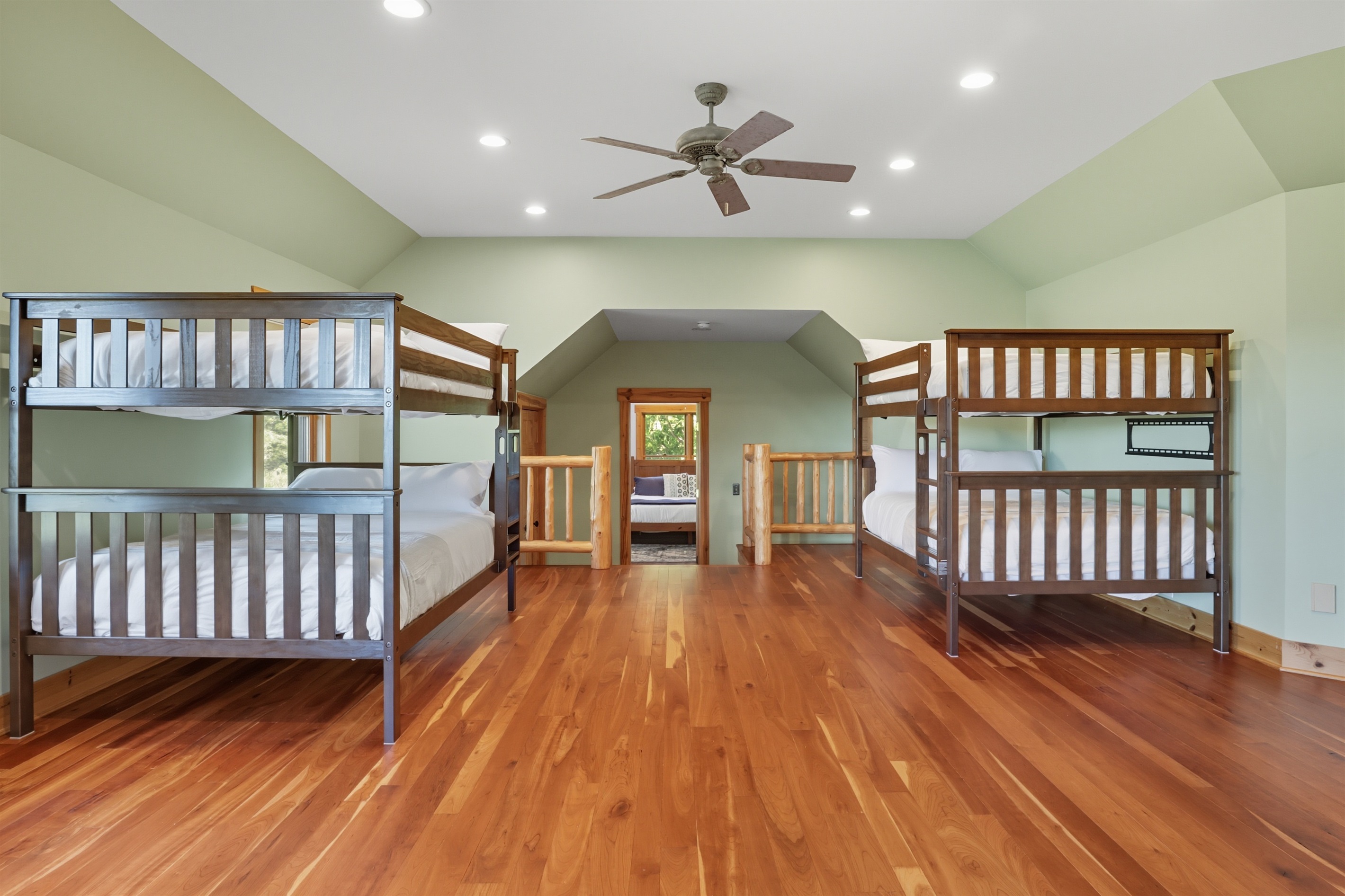 Bunk room designed for kids or groups, featuring multiple beds.