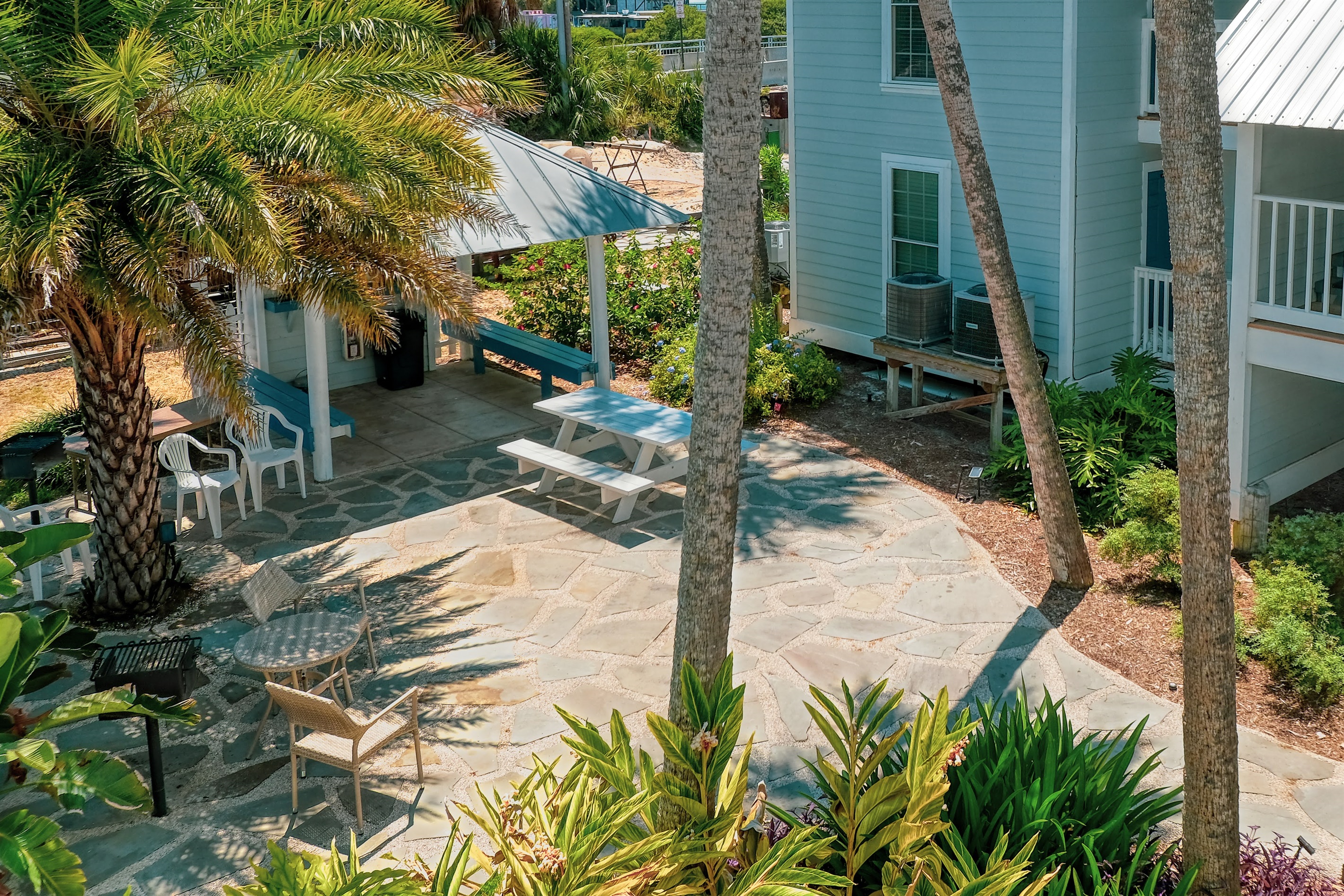 Shared patio area with grill, picnic table and bistro table and chairs