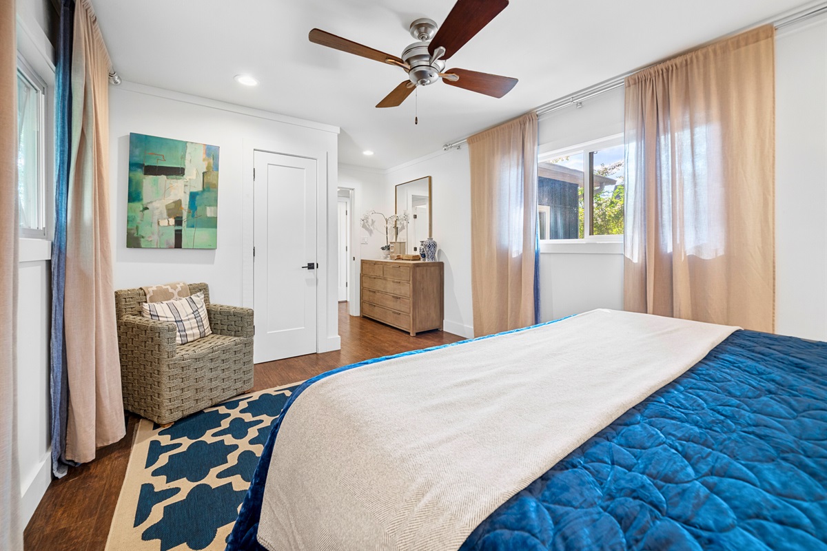 King bedroom with soft lighting and cozy blue tones for the perfect unwind.