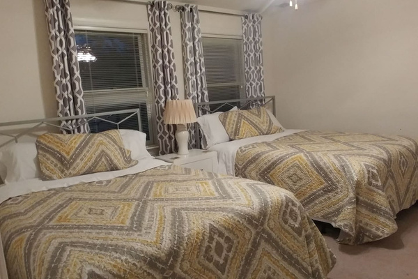 Yellow room with two queen beds. 
